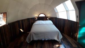 ein Schlafzimmer mit einem Bett und einem Fenster in der Unterkunft Biosfera Lodge in Olmué