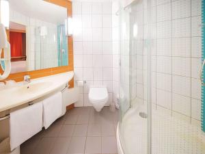 a bathroom with a toilet, sink, and shower at Ibis Yaroslavl Center in Yaroslavl