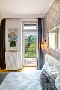 Posteľ alebo postele v izbe v ubytovaní Cracovia Apartments