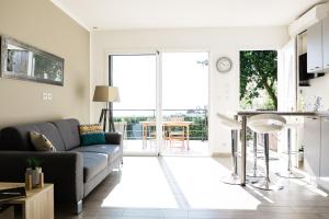 a living room with a couch and a table at Villa du Macchione BASTIA in Bastia