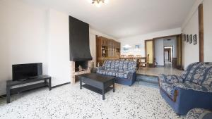 a living room with two couches and a fireplace at R28 APARTAMENTO MONTSERRAT 11-3 in Calafell