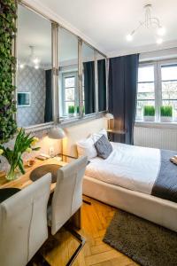 Posteľ alebo postele v izbe v ubytovaní Cracovia Apartments