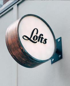 a barrel attached to a building with the word toilets at 506 Lofts in Nashville