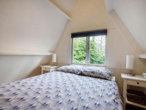 - une chambre avec un lit et une fenêtre dans l'établissement Traditional Holiday Home in Lanaken with Garden, à Lanaken