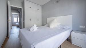 - une chambre blanche avec un grand lit blanc et 2 oreillers dans l'établissement R68 Apartamento Montserrat 32-3, à Calafell