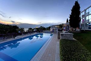 a large swimming pool in front of a building at Hotel Zorna Plava Laguna in Poreč