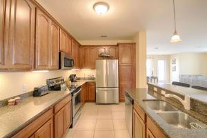 a kitchen with wooden cabinets and a stainless steel refrigerator at 5048 Viz Cay in Orlando