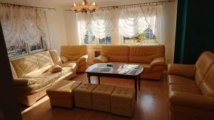a living room with couches and a coffee table at BASTÓWKA 2 Apartamenty in Ustroń