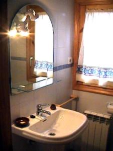 a bathroom with a sink and a mirror and a window at Tossal del Maig in Barbará