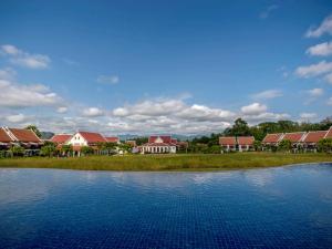 a group of houses and a body of water at Pullman Luang Prabang in Luang Prabang