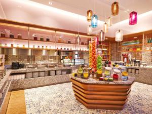 a large kitchen with a buffet in a restaurant at Mercure Kuala Lumpur Shaw Parade in Kuala Lumpur