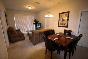 a living room with a table and a couch at 4114 Viz Cay in Orlando