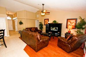 a living room with leather furniture and a fireplace at 217 Legacy Park in Davenport