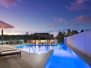 a swimming pool in the middle of a house at Pullman Brisbane Airport in Brisbane