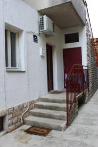 a building with stairs and a door with a air conditioner at Apartment MIS Floura in Rijeka