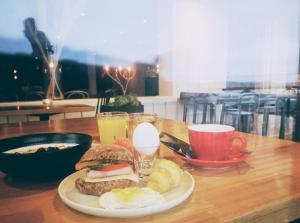 a plate of food with a sandwich on a table at Käringöns Vandrarhem in Käringön