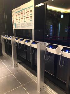 a row of cell phones on display in a store at Henn na Hotel Tokyo Haneda in Tokyo