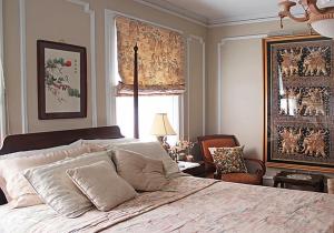 a bedroom with a large bed and a window at Port City Guest House in Wilmington