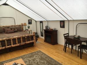 a bedroom with a bed and a desk and a table at North Forty Resort in Columbia Falls