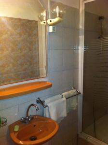 ショプロンにあるAlpesi Trimmel Vendégházのバスルーム(洗面台、ガラス張りのシャワー付)