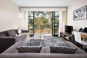 a living room filled with furniture and a large window at Quest Narre Warren in Narre Warren