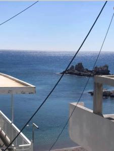 a view of the ocean from the balcony of a house at Georgias Apartments in Haraki