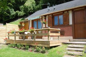 a house with a wooden deck in front of it at le chalet de la vallée in Bouquelon +18 photos