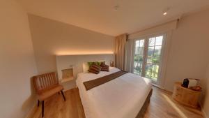 a bedroom with a large bed and a window at Hof Ter Beuke in Bruges