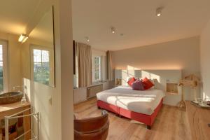 a hotel room with a bed and a mirror at Hof Ter Beuke in Bruges