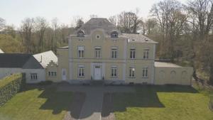 an aerial view of a large white house at Kasteel B&B Sint-Bartel in Geraardsbergen