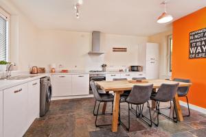 a kitchen with a wooden table and chairs at Beautiful City Centre House with Parking! Sleeps 6 in Sheffield