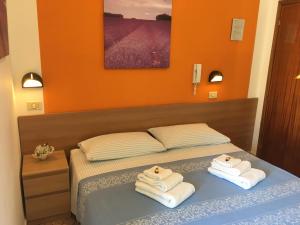 En eller flere senge i et værelse på Hotel Villa Rinaldini