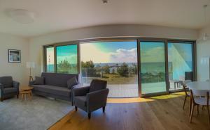 a living room with a couch and a large window at Jurata Residence in Jurata