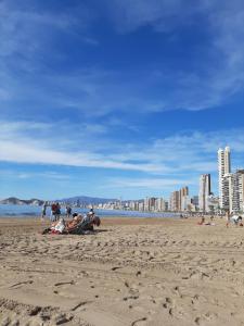 a group of people sitting on a beach at Moby dick 1D (Verblijf aan de costa) in Benidorm