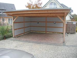 a garage with a cover on top of it at Ferienhaus Morgenstern F403 mit Kamin und Garten in Baabe