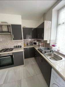 a kitchen with stainless steel appliances and a sink at 71 Travis street Burnley in Burnley