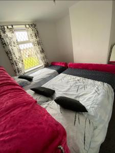 a bedroom with a bed with pillows and a window at 71 Travis street Burnley in Burnley