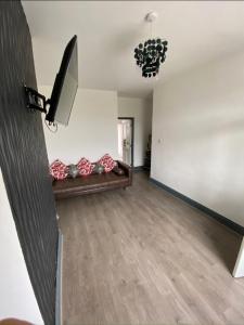 a living room with a couch and a chandelier at 71 Travis street Burnley in Burnley