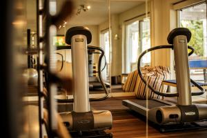 a gym with two exercise bikes in a room at Hotel Saraceno Resort in Milano Marittima
