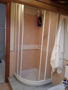 a shower with a glass door in a bathroom at B&B Suite in Viagrande
