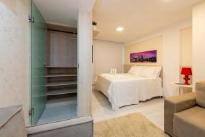Säng eller sängar i ett rum på Águia Flats Pousada