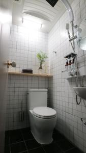 a white bathroom with a toilet and a sink at Hostel Korea - Original in Seoul