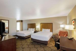 
a hotel room with two beds and a television at La Quinta by Wyndham Las Vegas RedRock/Summerlin in Las Vegas
