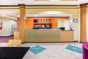 a lobby of a hotel with a reception desk at La Quinta by Wyndham Raleigh Cary in Cary