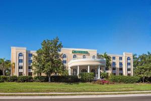 a large white building with a porch at La Quinta by Wyndham Sarasota Downtown in Sarasota