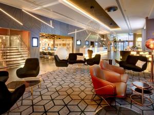 a lobby with couches and chairs in a building at Pullman London St Pancras in London