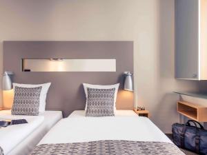 Postel nebo postele na pokoji v ubytování Mercure Hotel Düsseldorf City Nord