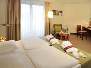 A bed or beds in a room at Mercure Tagungs- & Landhotel Krefeld