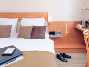 Postel nebo postele na pokoji v ubytování Mercure Hotel Mannheim am Rathaus
