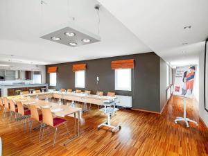 a large room with a long table and chairs at Ibis Praha Old Town in Prague